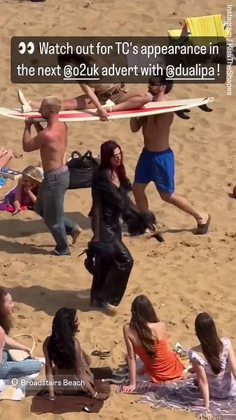 Dua Lipa struts across the sand on film set for O2 advert video shoot