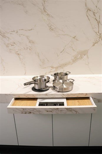 Experience a completely new way of cooking with Invisacook, the revolutionary invisible induction cooktop that transforms your countertop into a fully functional cooking surface. With no visible burners or bulky appliances, your kitchen stays sleek, modern, and beautifully minimalistic. Using advanced magnetic induction technology, Invisacook heats the cookware directly while keeping the countertop itself cool and safe to touch. This means you can cook, prep, and serve all in one seamless space 