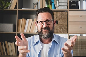 portrait and close up of one old man talking to the camera in video...
